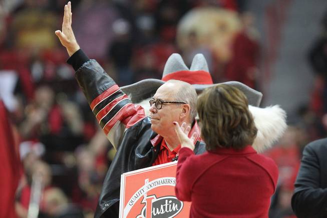 Outgoing UNLV President Neal Smatresk waves to the crowd after being honored during a timeout in their game against Sacred Heart Friday, Dec. 20, 2013 at the Thomas & Mack Center. UNLV won the game 82-50.